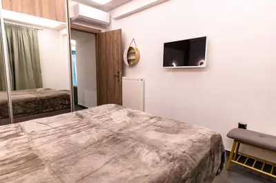 a hotel room with a bed and a tv on the wall at Fix Central Athens Nomads in Athens