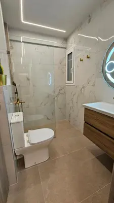 a bathroom with a toilet and a shower and a sink at Mark2 by Apollo in Markopoulo
