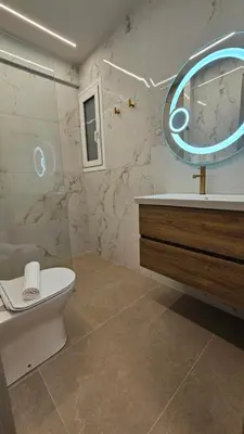 a bathroom with a toilet and a sink and a mirror at Mark2 by Apollo in Markopoulo