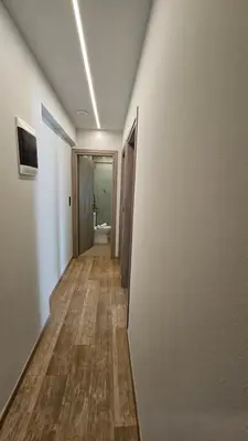 a hallway leading to a bathroom with a toilet at Mark2 by Apollo in Markopoulo