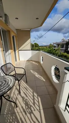 a balcony with a table and chairs on a balcony at Mark2 by Apollo in Markopoulo