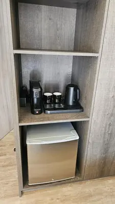 a shelf with two coffee pots and a box at Mark2 by Apollo in Markopoulo