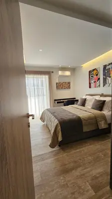 a bedroom with a large bed and a window at Mark2 by Apollo in Markopoulo