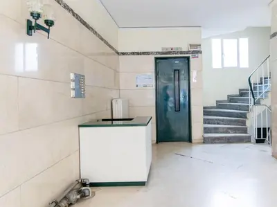 a hallway with a door and stairs in a building at Nataly's Vibrant 2BR - 4 mins walk to Acropolis in Athens