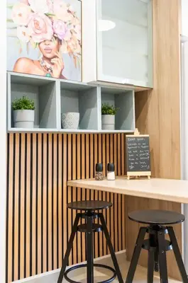a counter with two stools in a room at Nataly's Vibrant 2BR - 4 mins walk to Acropolis in Athens