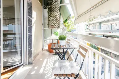a balcony with a table and chairs on it at Nataly's Vibrant 2BR - 4 mins walk to Acropolis in Athens