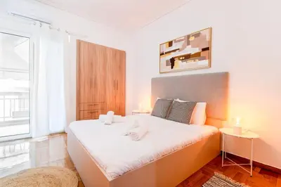 a bedroom with a large bed in a room at Nataly's Vibrant 2BR - 4 mins walk to Acropolis in Athens