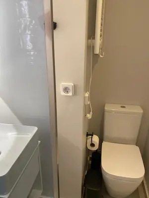 a small bathroom with a toilet and a sink at ErexthionDiony2Apartments in Athens