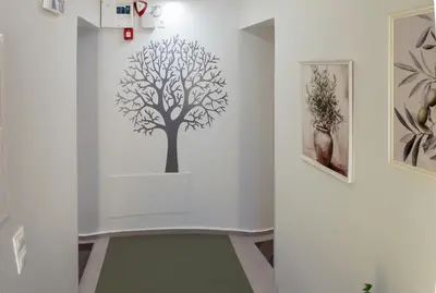 a white wall with a tree stencil on it at ErexthionDiony2Apartments in Athens