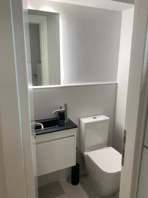 a bathroom with a toilet and a sink and a mirror at ErexthionDiony2Apartments in Athens