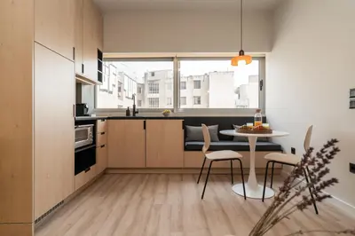 a kitchen with a table and chairs and a window at Elegant Suite - Aiolou Street in Athens