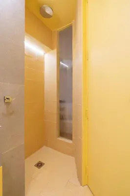 a bathroom with a shower with a glass door at Elegant Suite - Aiolou Street in Athens