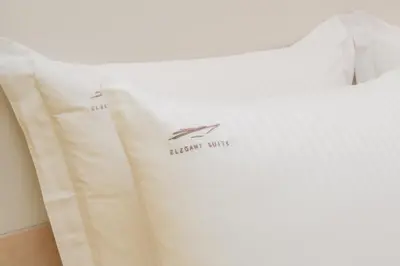 a white bed with a pillow with a boat on it at Elegant Suite - Aiolou Street in Athens