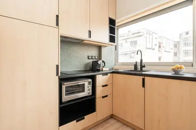 a kitchen with a microwave oven and a sink at Elegant Suite - Aiolou Street in Athens