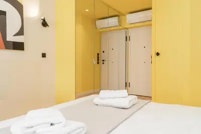 two towels sitting on top of a bed in a room at Elegant Suite - Aiolou Street in Athens