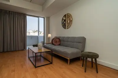 a living room with a couch and a table at Kifisias View Apartment 2 in Athens