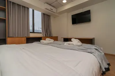 a bedroom with a large bed with towels on it at Kifisias View Apartment 2 in Athens