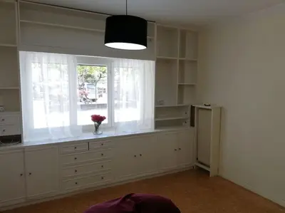 a kitchen with a window and a vase of flowers at ArtHouse near the sea and the city center in Athens