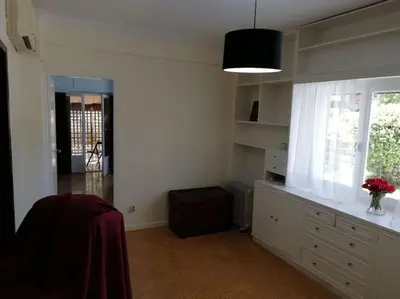 a white kitchen with a window and a vase of flowers at ArtHouse near the sea and the city center in Athens