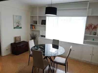 a dining room with a glass table and chairs at ArtHouse near the sea and the city center in Athens