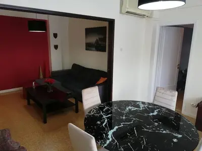 a living room with a table and a couch at ArtHouse near the sea and the city center in Athens