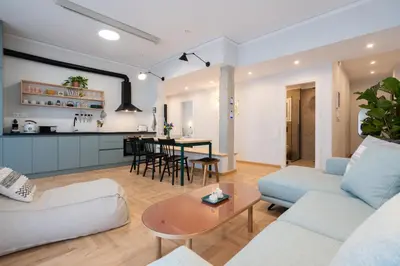 a living room with a couch and a table at 3BR Petralona Escape in Athens