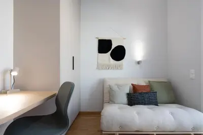 a workspace with a white couch and a desk at 3BR Petralona Escape in Athens