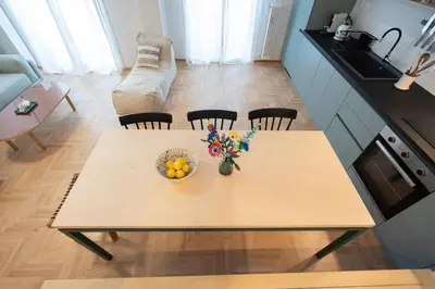 a table in a kitchen with a bowl of fruit on it at 3BR Petralona Escape in Athens
