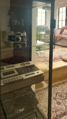 a glass display in a living room with a machine at Epicurus Loft in Athens