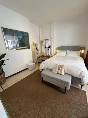 a bedroom with a bed and a chair in it at Epicurus Loft in Athens