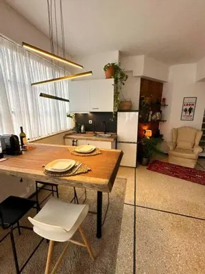 a kitchen with a table and chairs in a room at Epicurus Loft in Athens