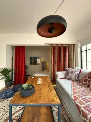 a living room with a couch and a wooden table at Epicurus Loft in Athens