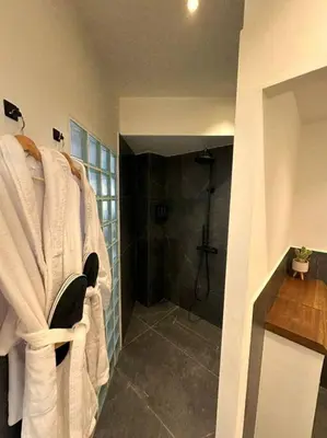 a bathroom with a shower with white towels at Epicurus Loft in Athens