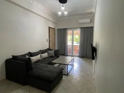 a living room with a couch and a table at Nikea apartment near Pireus port and metro st III in Piraeus