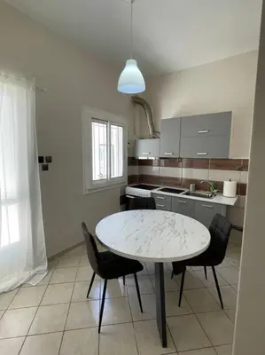 a kitchen with a table and chairs in it at Nikea apartment near Pireus port and metro st III in Piraeus