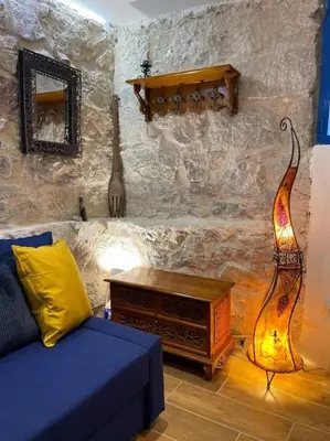 a living room with a blue couch and a lamp at Akropole 700 m Koukaki Merkez in Athens