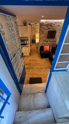 a stairway leading to a living room and a kitchen at Akropole 700 m Koukaki Merkez in Athens