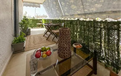 a balcony with a bowl of fruit on a glass table at Nice Apartment In Anavissos With Wifi in Anavissos