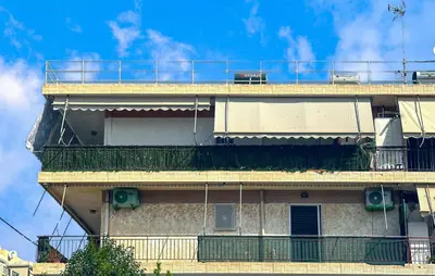 a building with a balcony on the side of it at Nice Apartment In Anavissos With Wifi in Anavissos