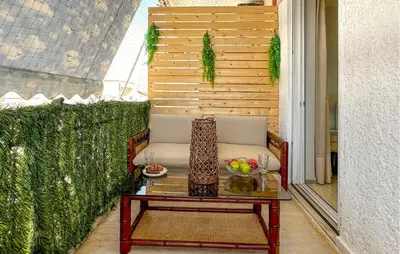 a table and a chair on a balcony with a table sidx sidx at Nice Apartment In Anavissos With Wifi in Anavissos