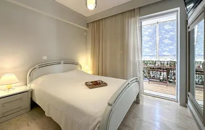 a bedroom with a bed and a large window at Nice Apartment In Anavissos With Wifi in Anavissos