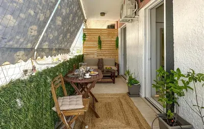 a small patio with a table and chairs on a balcony at Nice Apartment In Anavissos With Wifi in Anavissos