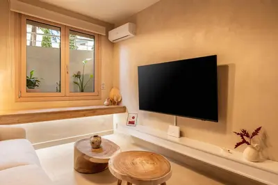 a living room with a flat screen tv on the wall at Gaia Nest in Piraeus