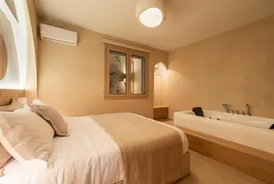 a bedroom with a bed and a bath tub at Gaia Nest in Piraeus