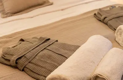 a pair of socks and a cast on a bed at Gaia Nest in Piraeus
