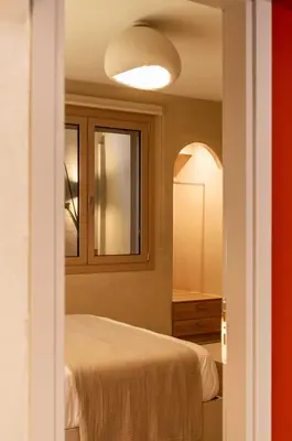 a bedroom with a bed and a mirror at Gaia Nest in Piraeus