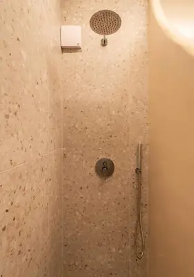 a shower with a shower head in a bathroom at Gaia Nest in Piraeus
