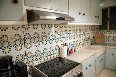 a kitchen with a sink and a tile wall at Acropolis central and comfortable apartment in Athens