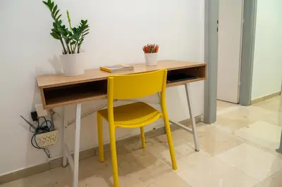 a yellow chair sitting at a desk with a yellow desk at Acropolis central and comfortable apartment in Athens