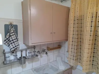 a kitchen with a sink and a cabinet at Φιλόξενο studio στο Γαλάτσι in Athens